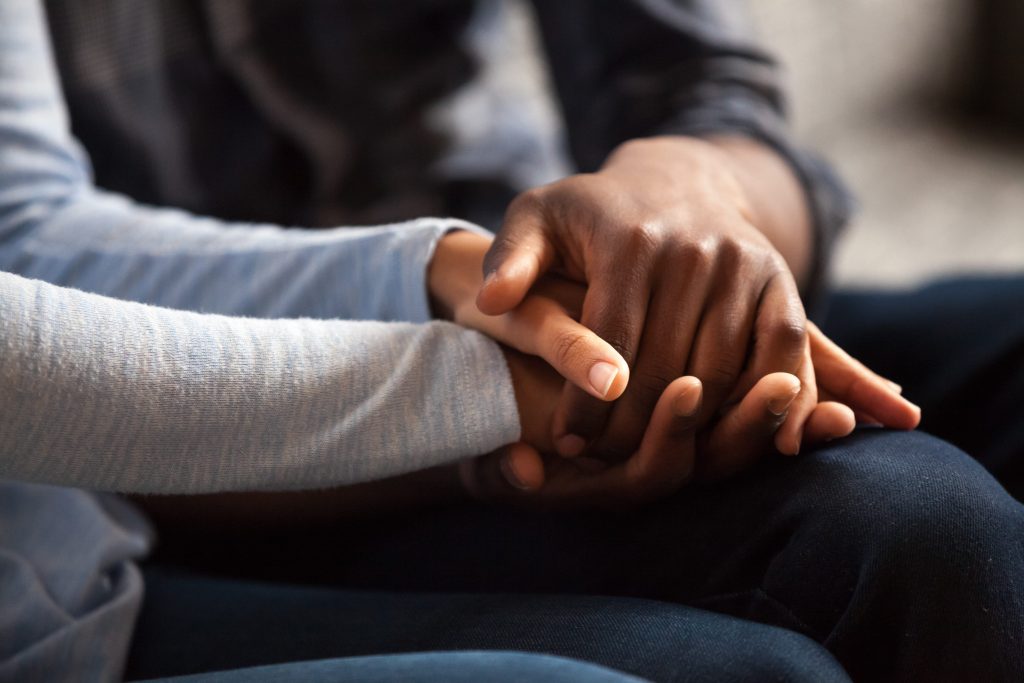 couple holding hands close up