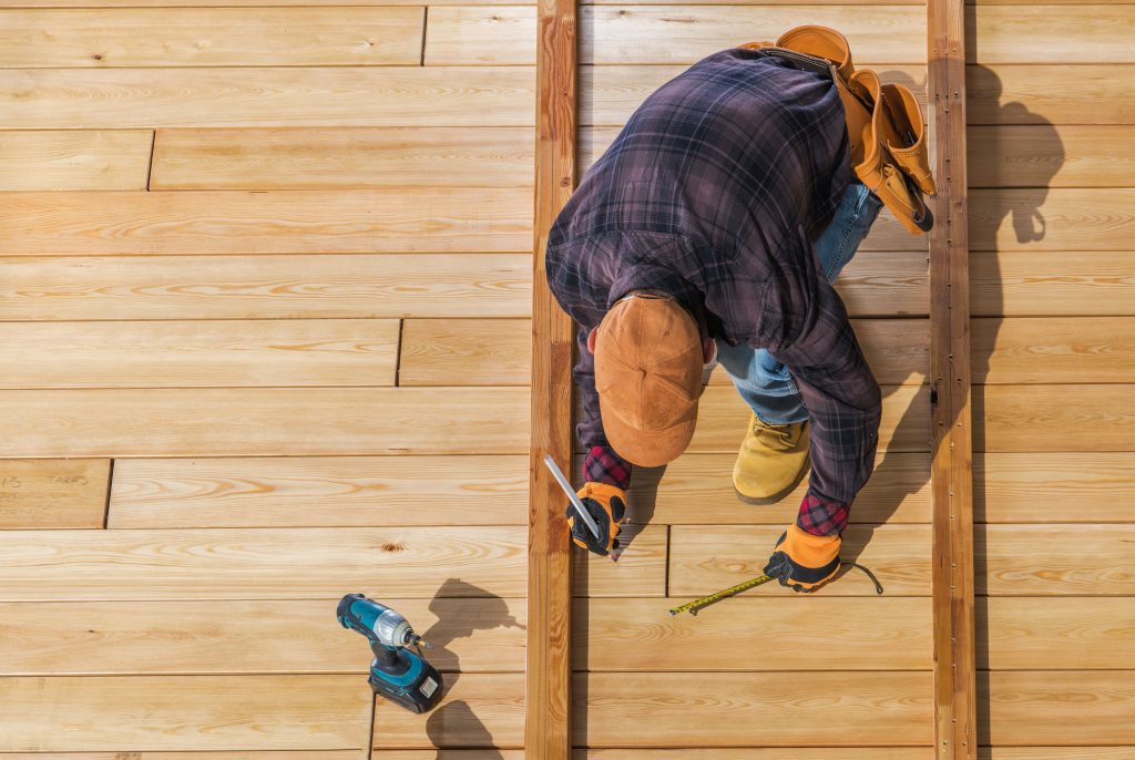 roofer nailing boards to roof