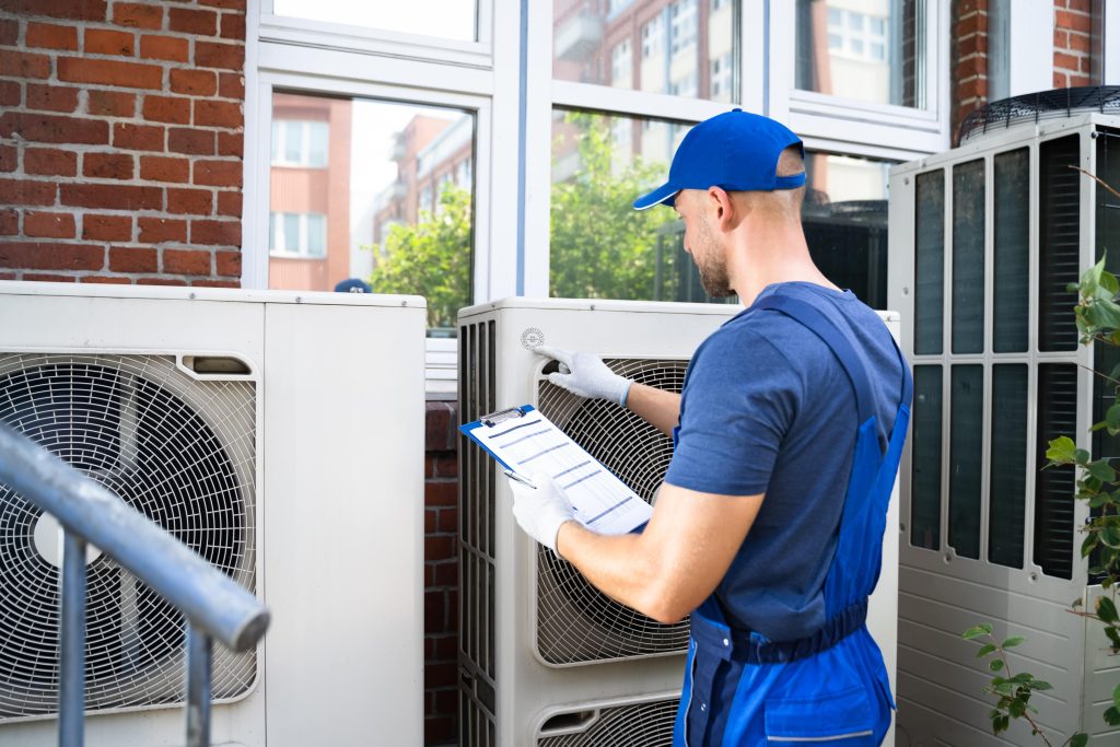 hvac technician working on ac unit