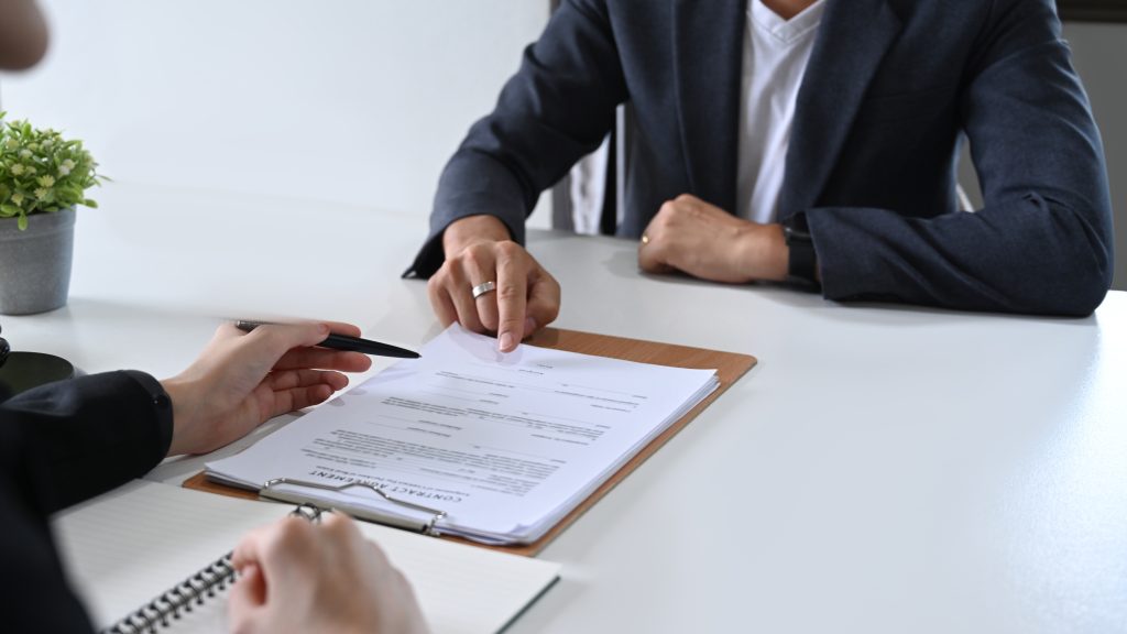 man and woman reviewing paperwork at desk