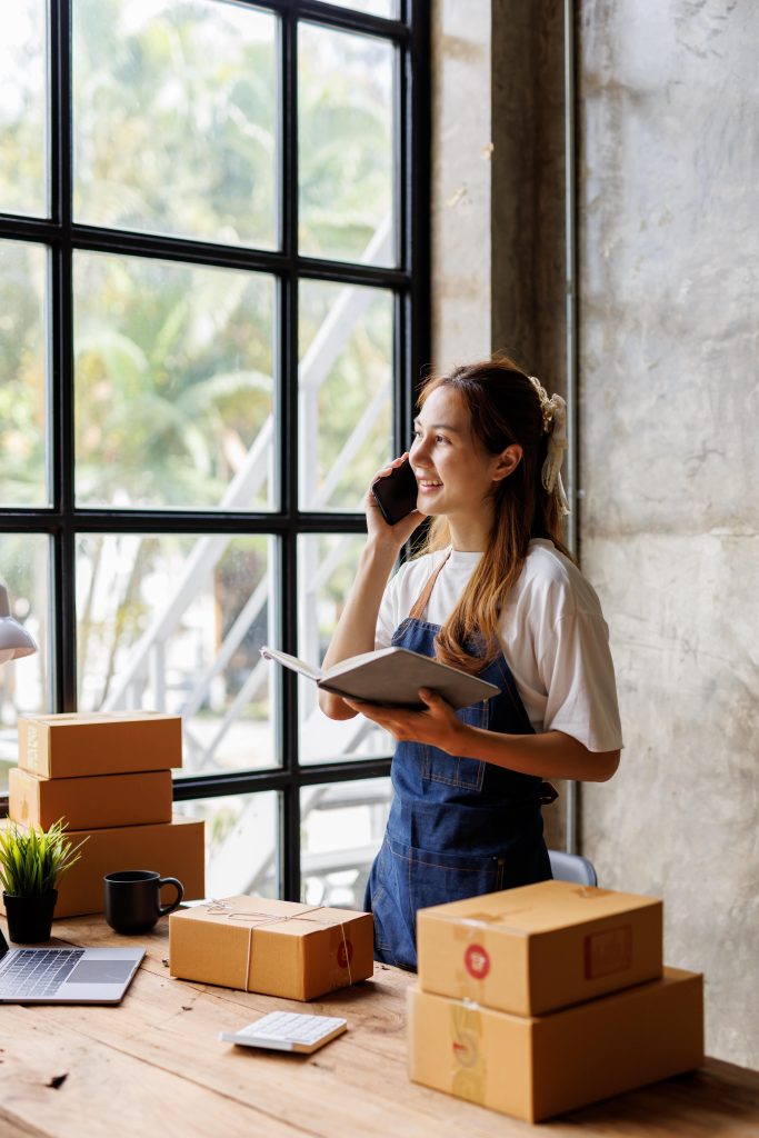 woman on the phone with tablet and boxes