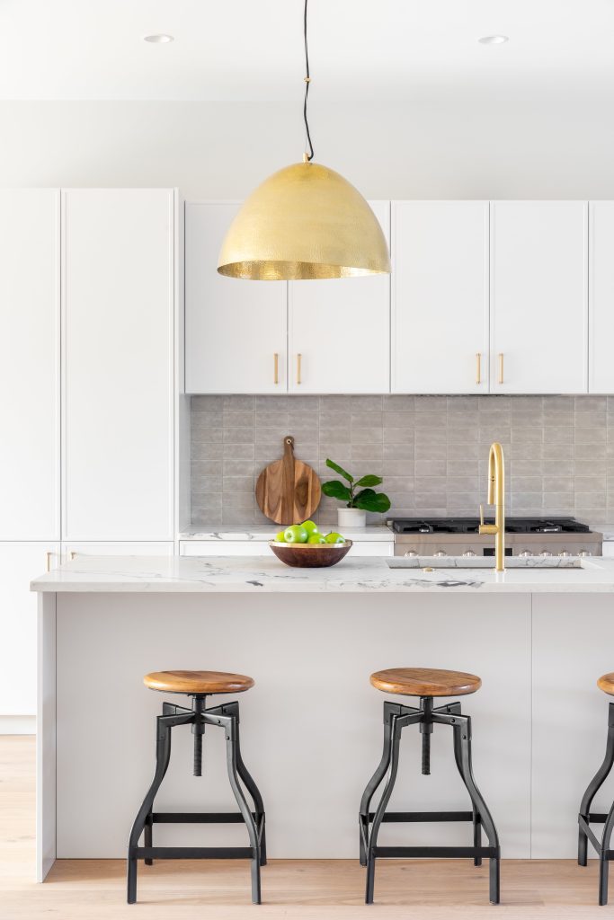 remodeled kitchen modern finishes with gold pendant light