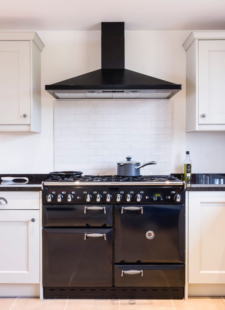 kitchen remodeled with black appliances and overhead vent