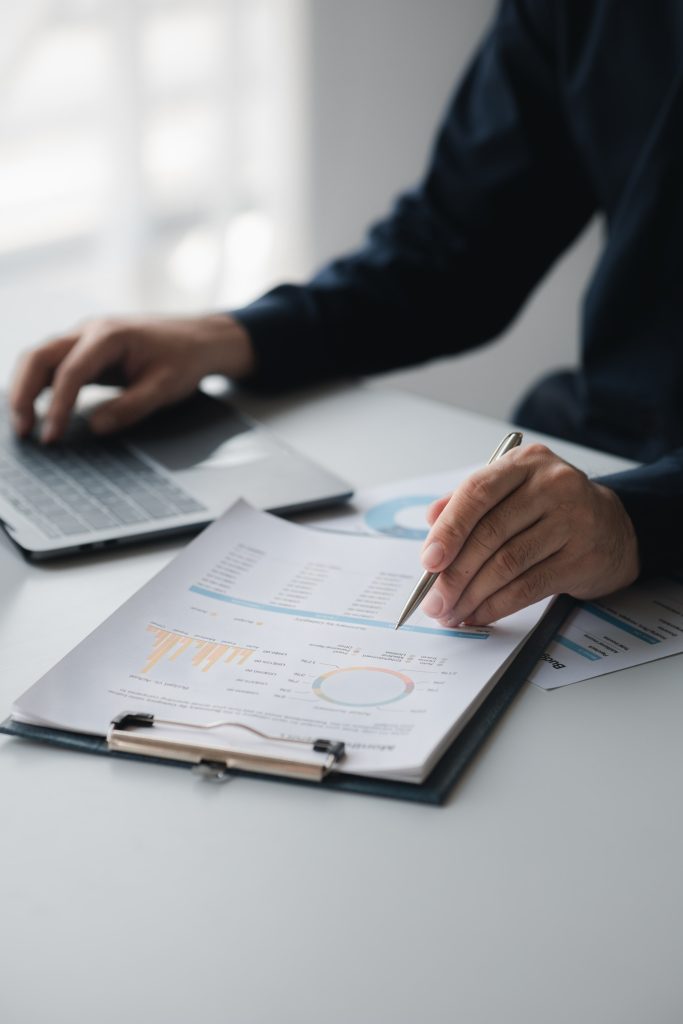 man at laptop reviewing financial documents