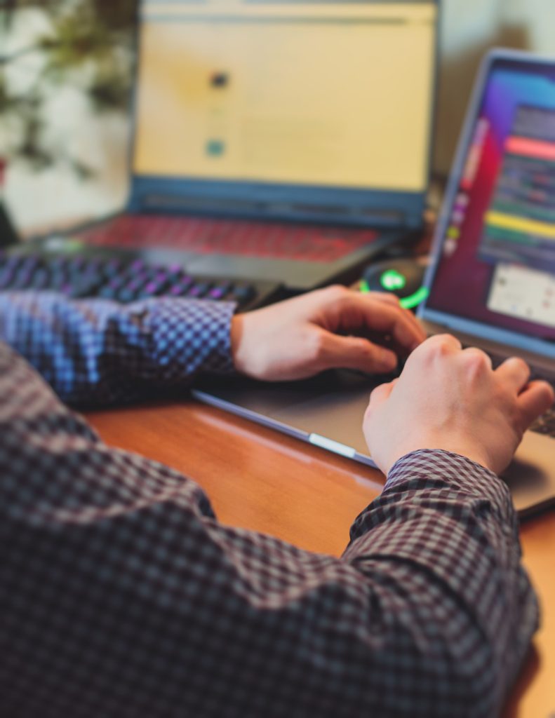 man at computer with checkered shirt